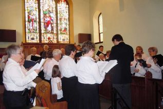 Brad Barbeau conducting John Staynor's “The Crucifixion” in 2014 at St. Paul's Anglican church in Sydenham